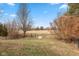 Large fenced backyard with mature trees, offering privacy and space for outdoor activities at 4704 Whitview Ln, Indianapolis, IN 46237