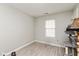Bright bedroom with neutral walls, wood-look flooring, and a window for natural light at 4704 Whitview Ln, Indianapolis, IN 46237
