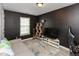 Cozy bedroom with dark gray walls, plush carpet, and a large window for natural light at 4704 Whitview Ln, Indianapolis, IN 46237
