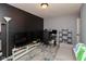 Spacious room with dark accent wall, neutral walls, wood-look flooring, and natural light at 4704 Whitview Ln, Indianapolis, IN 46237