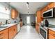 Well-lit kitchen with stainless steel appliances, light wood cabinets and sleek countertops at 4704 Whitview Ln, Indianapolis, IN 46237