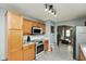 Well-lit kitchen with stainless steel appliances, light wood cabinets and sleek countertops at 4704 Whitview Ln, Indianapolis, IN 46237