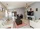 Bright living room with a ceiling fan, a stylish fireplace and a decorative wood accent wall at 4704 Whitview Ln, Indianapolis, IN 46237