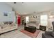 Bright living room with a ceiling fan, wood laminate flooring, a red front door and accent wall at 4704 Whitview Ln, Indianapolis, IN 46237