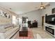 Bright living room with a ceiling fan, a stylish fireplace and a decorative wood accent wall at 4704 Whitview Ln, Indianapolis, IN 46237