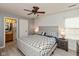 Spacious main bedroom boasts a ceiling fan, two windows for natural light, and ensuite bathroom at 4704 Whitview Ln, Indianapolis, IN 46237