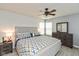Spacious main bedroom boasts a ceiling fan, two windows for natural light, and neutral-toned walls at 4704 Whitview Ln, Indianapolis, IN 46237