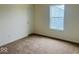 Cozy bedroom featuring neutral carpet and natural light from a large window at 476 Haywood Dr, Greenfield, IN 46140