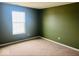 This bedroom features neutral carpet and an abundance of natural light from a large window at 476 Haywood Dr, Greenfield, IN 46140