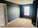 Cozy bedroom with plush carpeting and a window, offering a comfortable and private retreat at 476 Haywood Dr, Greenfield, IN 46140