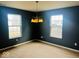 Formal dining room featuring neutral carpet, chandelier, and natural light, creating an elegant dining space at 476 Haywood Dr, Greenfield, IN 46140