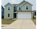 Charming two-story home with a two-car garage and manicured lawn, perfect for suburban living at 476 Haywood Dr, Greenfield, IN 46140
