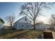 Backyard of the home featuring a tree and partially fenced-in yard at 5068 W 10Th St, Indianapolis, IN 46224