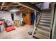 Unfinished basement featuring exposed ceiling and staircase at 5068 W 10Th St, Indianapolis, IN 46224