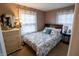 Relaxing bedroom with floral bedding, soft lighting, and a serene atmosphere for restful nights at 5068 W 10Th St, Indianapolis, IN 46224