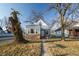 Charming home with a neatly kept front yard and mature trees, offers classic curb appeal at 5068 W 10Th St, Indianapolis, IN 46224
