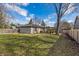 Expansive backyard with mature trees and a partially covered patio area at 5451 Buttonwood Dr, Noblesville, IN 46062