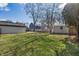 Large, grassy backyard featuring a storage shed and mature trees at 5451 Buttonwood Dr, Noblesville, IN 46062