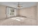Bedroom features neutral walls, carpet, ceiling fan, and a window for natural light at 5451 Buttonwood Dr, Noblesville, IN 46062