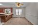 Traditional kitchen area features wood breakfast bar, double hung window, and neutral carpeting at 5451 Buttonwood Dr, Noblesville, IN 46062