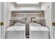 Well-organized laundry room equipped with two washing machines and overhead shelving at 5451 Buttonwood Dr, Noblesville, IN 46062