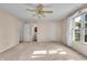 Primary bedroom boasts neutral walls, neutral carpet, ceiling fan, and an adjacent bathroom at 5451 Buttonwood Dr, Noblesville, IN 46062