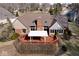 Aerial shot reveals a well-maintained backyard, partially covered deck, brick chimney, and attractive landscaping at 5519 Fall Creek Rd, Indianapolis, IN 46220