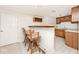 Basement bar featuring tile floors, sink, wooden bar with seating, cabinets, and wine rack at 5519 Fall Creek Rd, Indianapolis, IN 46220