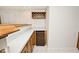 Basement bar featuring white countertop, cabinets, wooden bar, and beverage cooler at 5519 Fall Creek Rd, Indianapolis, IN 46220