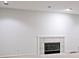 Basement fireplace with tile surround, carpeted floors, and white walls at 5519 Fall Creek Rd, Indianapolis, IN 46220