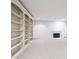 Spacious basement features a fireplace and custom built-in shelving and storage at 5519 Fall Creek Rd, Indianapolis, IN 46220