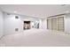 Finished basement featuring built-in shelving, carpeting, and an open layout leading to a bar area at 5519 Fall Creek Rd, Indianapolis, IN 46220