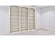 Finished basement featuring built-in shelving with white walls and carpeted floors at 5519 Fall Creek Rd, Indianapolis, IN 46220