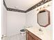 Bathroom featuring linoleum floors, wallpaper border, vanity, octagon mirror, and toilet at 5519 Fall Creek Rd, Indianapolis, IN 46220