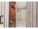 Hall bathroom features a shower-tub combination with a glass door and safety bar at 5519 Fall Creek Rd, Indianapolis, IN 46220