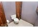 Small bathroom features a toilet and a tall wooden cabinet for storage at 5519 Fall Creek Rd, Indianapolis, IN 46220