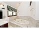 Bathroom featuring a soaking tub, tiled accents, and a large vanity at 5519 Fall Creek Rd, Indianapolis, IN 46220