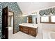 Bathroom featuring double vanity, vaulted ceiling, and a soaking tub at 5519 Fall Creek Rd, Indianapolis, IN 46220