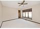 Neutral bedroom features a plush carpet and an oversized picture window at 5519 Fall Creek Rd, Indianapolis, IN 46220