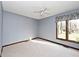 Bedroom features a window overlooking a backyard with neutral carpet at 5519 Fall Creek Rd, Indianapolis, IN 46220