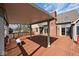 This is a spacious covered deck featuring sturdy columns, a white bench, and an overhead view of the backyard and deck at 5519 Fall Creek Rd, Indianapolis, IN 46220