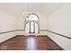 Elegant dining room featuring hardwood floors, chandelier, and a large arched window at 5519 Fall Creek Rd, Indianapolis, IN 46220