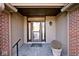 Covered entryway with a decorative glass front door and a brick accent wall at 5519 Fall Creek Rd, Indianapolis, IN 46220