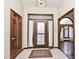 Foyer with a decorative front door, tiled floor, and arched doorway at 5519 Fall Creek Rd, Indianapolis, IN 46220