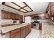 Well-lit kitchen features granite countertops, stainless steel appliances, and ample cabinet space at 5519 Fall Creek Rd, Indianapolis, IN 46220