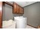 Laundry room featuring a washer, dryer, utility sink and storage cabinets at 5519 Fall Creek Rd, Indianapolis, IN 46220