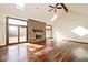 Bright living room showcases hardwood floors, brick fireplace, and access to the deck at 5519 Fall Creek Rd, Indianapolis, IN 46220