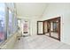 Bright sunroom features tile flooring, ample windows, and access to both the exterior and interior at 5519 Fall Creek Rd, Indianapolis, IN 46220