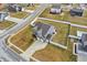 Aerial view of a home with a spacious backyard and three-car garage in a residential neighborhood at 61 Larimar Way, Whiteland, IN 46184