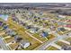Sprawling neighborhood showcasing meticulously maintained homes, green spaces, and a serene lake at 61 Larimar Way, Whiteland, IN 46184
